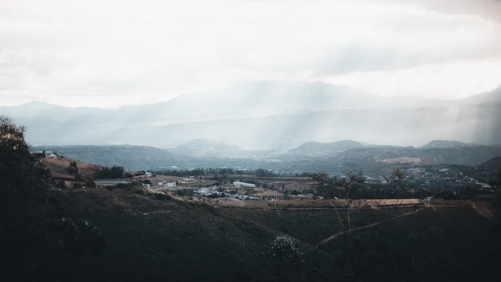 a view of a valley with mountains in the background