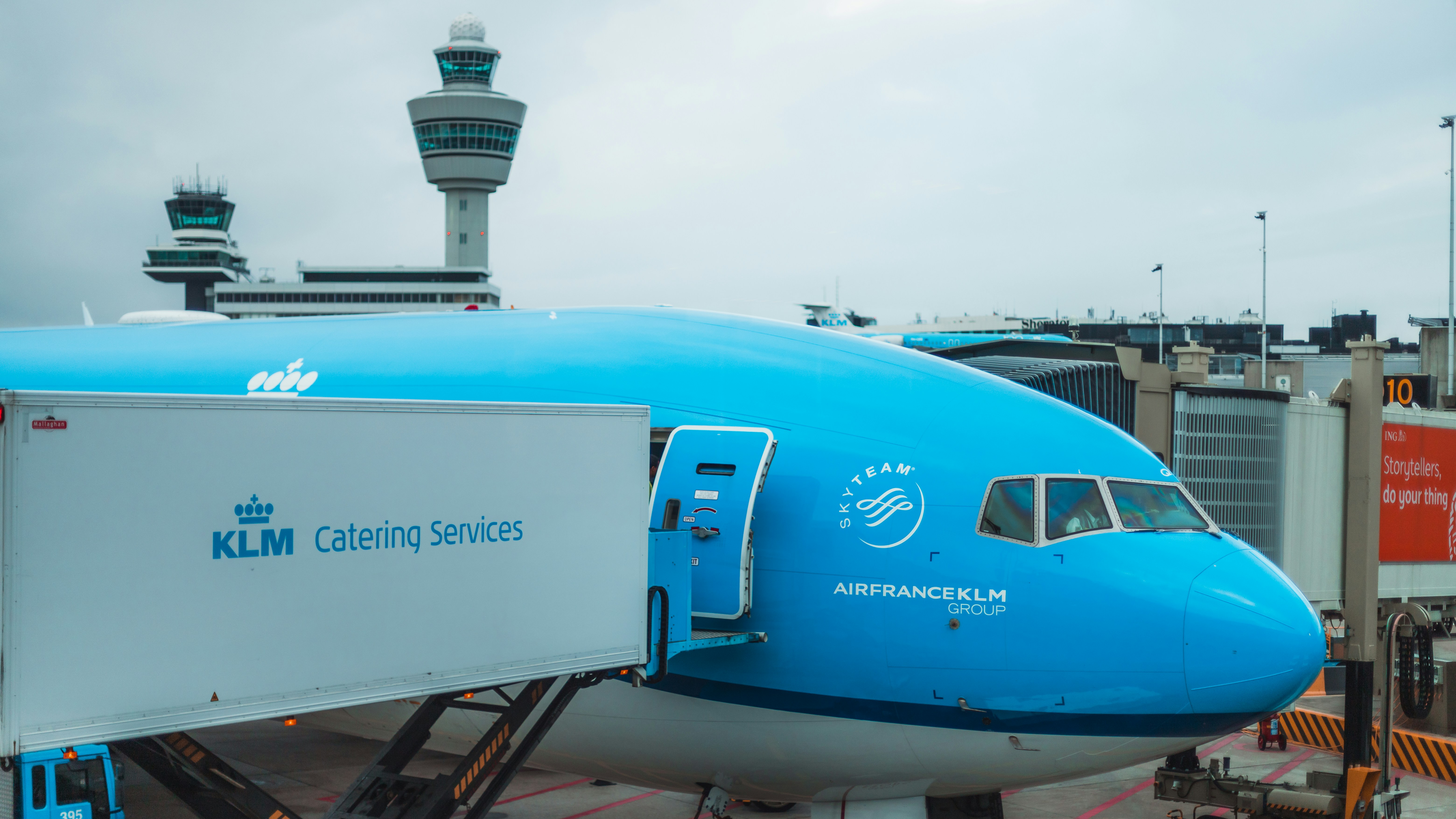 a blue and white airplane is parked at an airport
