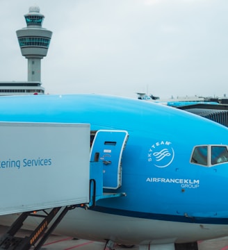 a blue and white airplane is parked at an airport