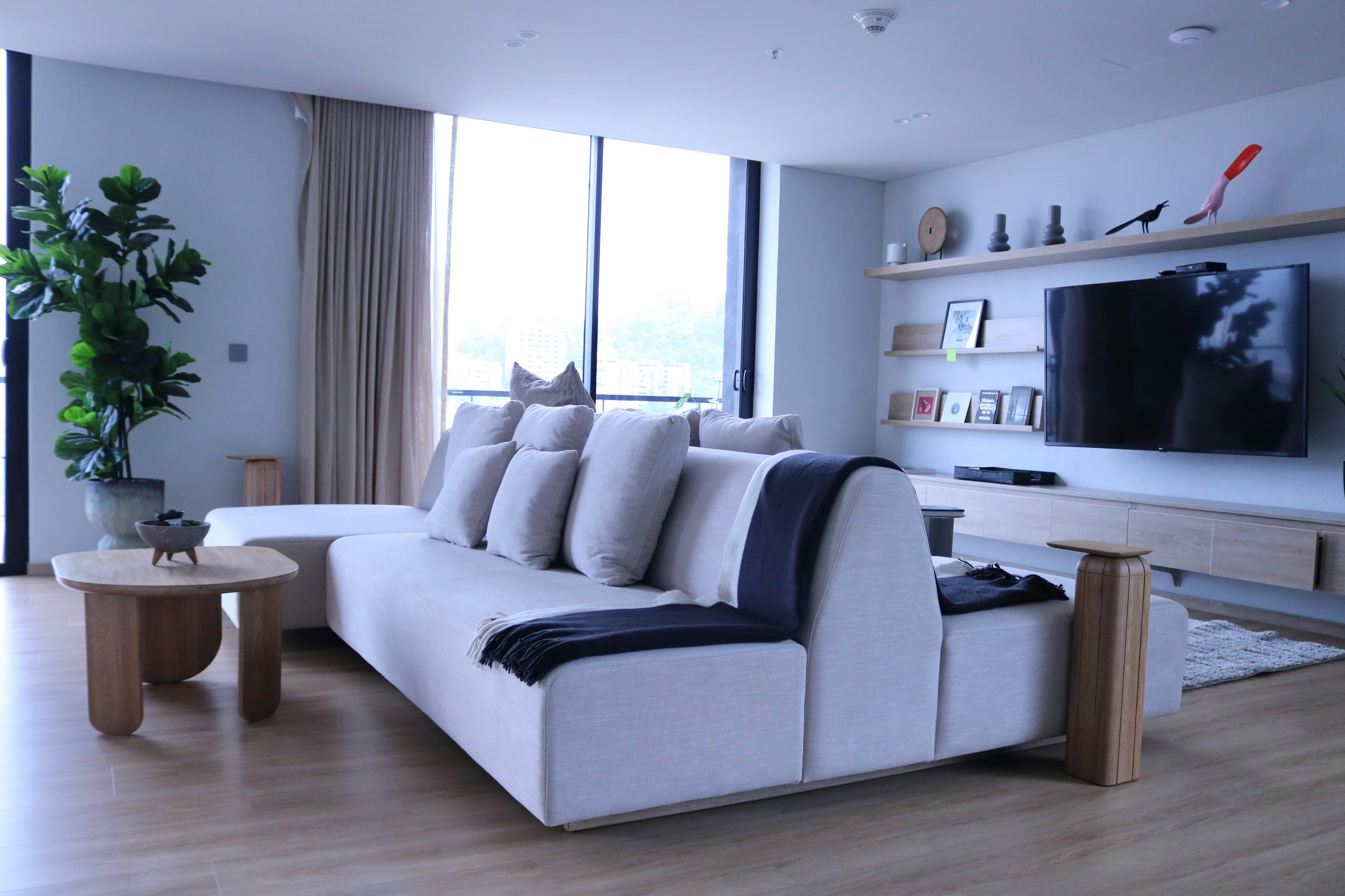 a living room filled with furniture and a flat screen tv