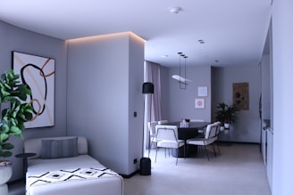 a living room filled with furniture and a painting on the wall