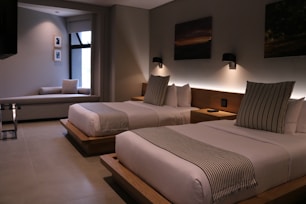 Elegant hotel room with double beds and warm lighting