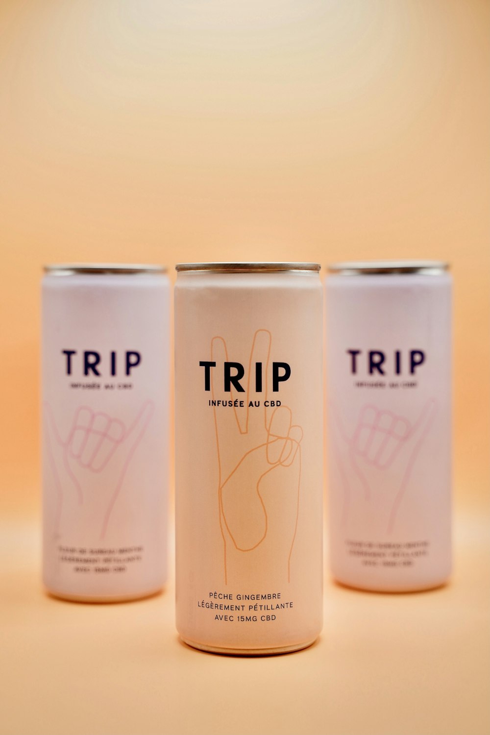 three cans of trip beer on a table