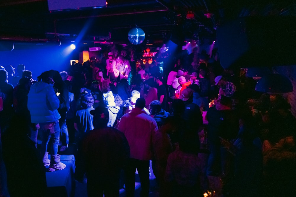 a group of people standing in a dark room