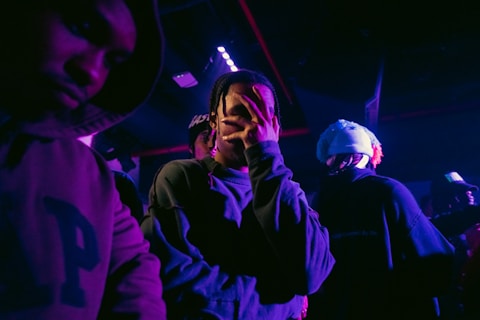 a group of people standing in a dark room