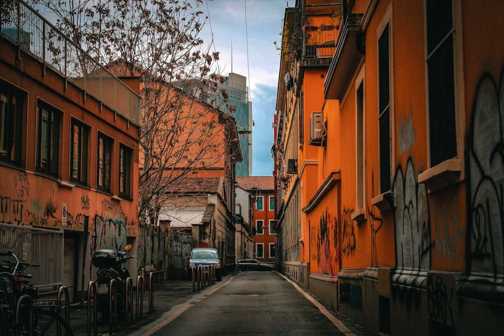 a narrow city street lined with orange buildings