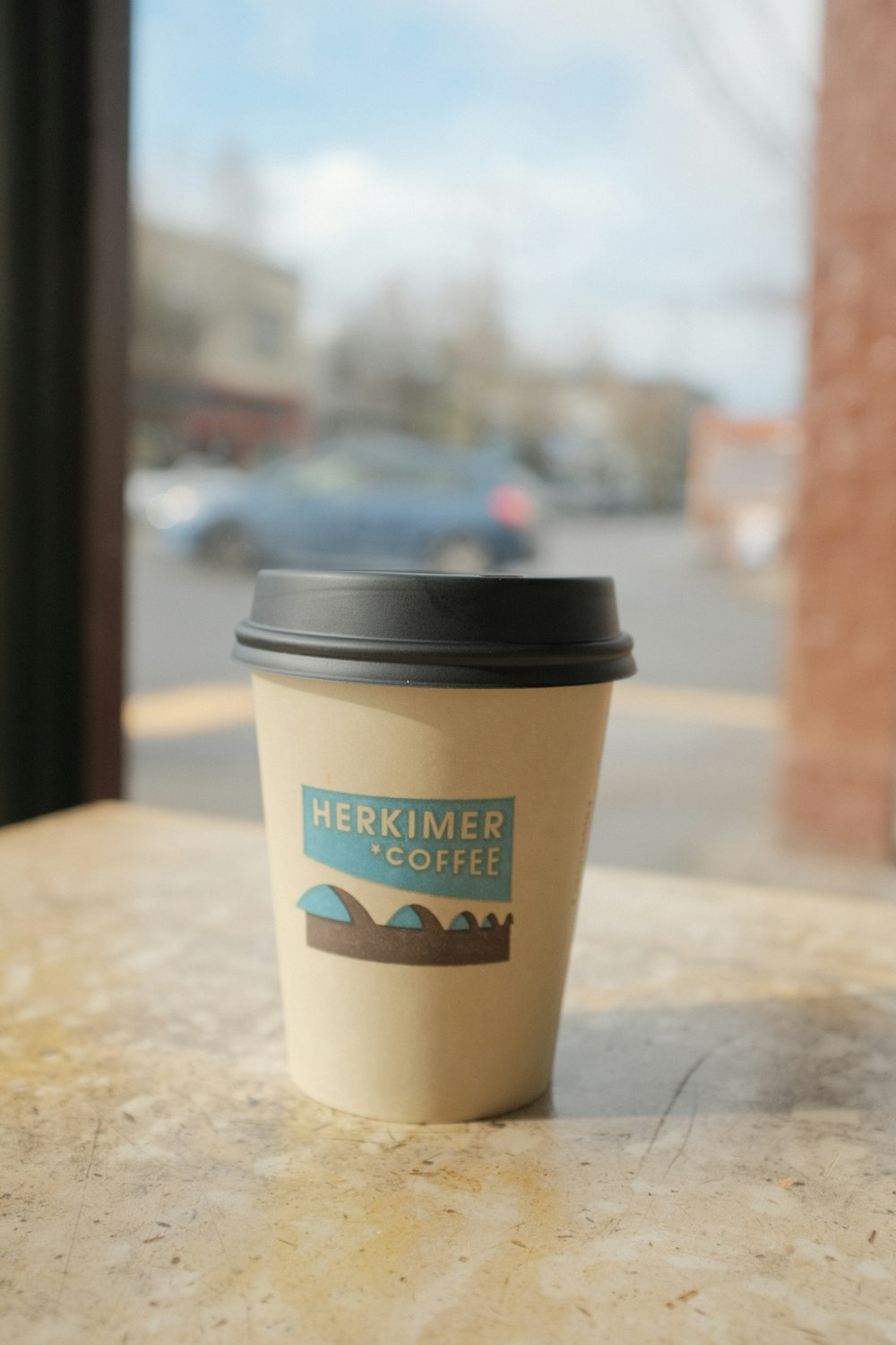 a cup of coffee sitting on top of a table