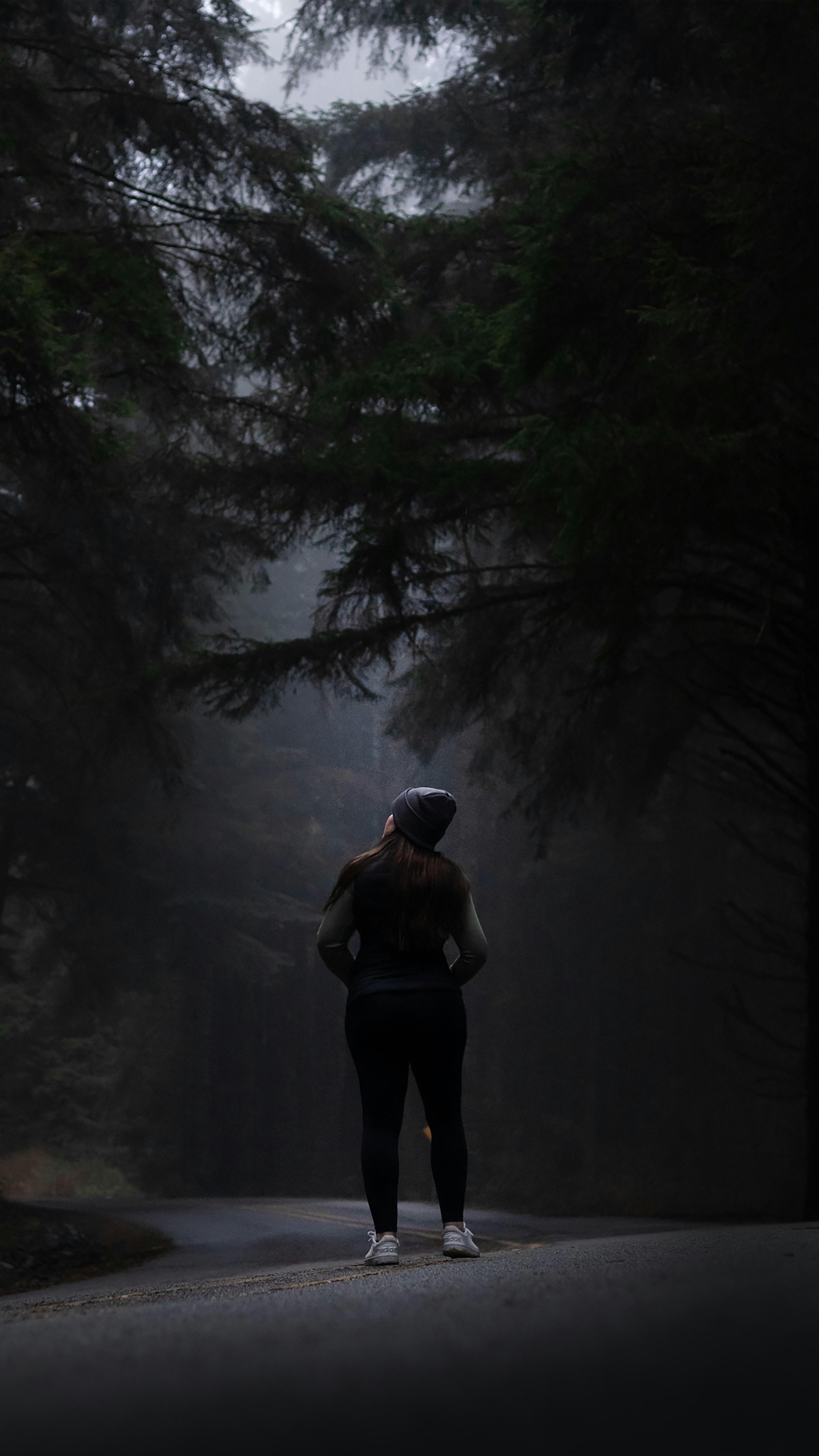 Athlete standing calmly in a forest environment representing nervous system regulation and mental focus for athletic performance