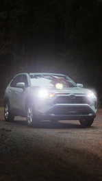 a car driving down a road at night