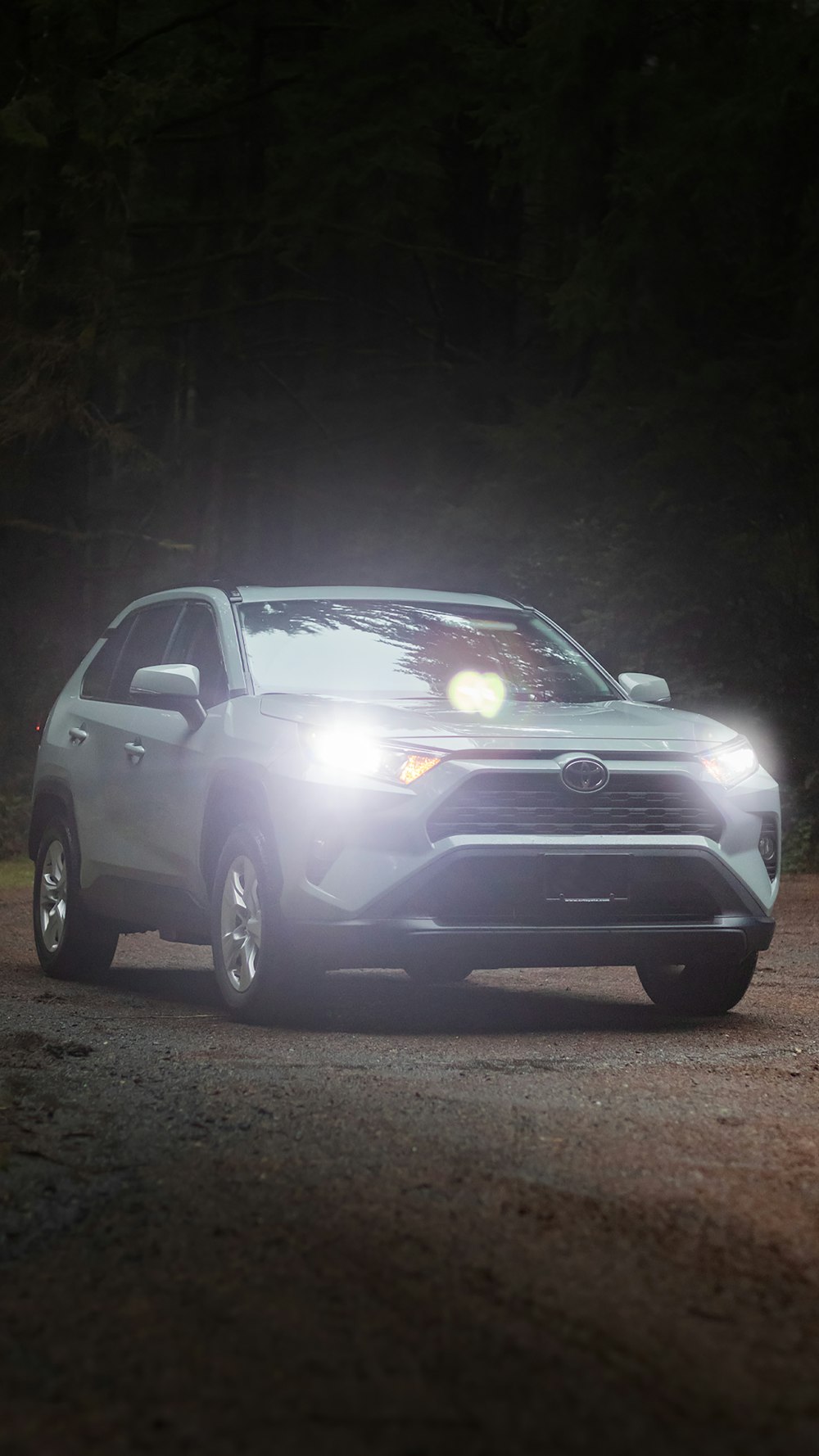 a car driving down a road at night