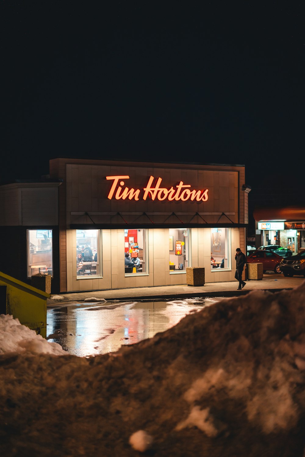 a tim hortons store at night in the snow
