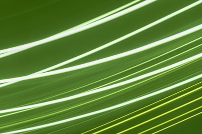 Bright lines of light streak across a green background, creating a sense of motion and energy.