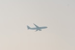 a large jetliner flying through a cloudy sky