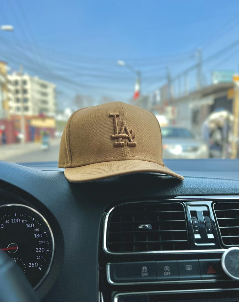 a baseball cap sitting on the dashboard of a car