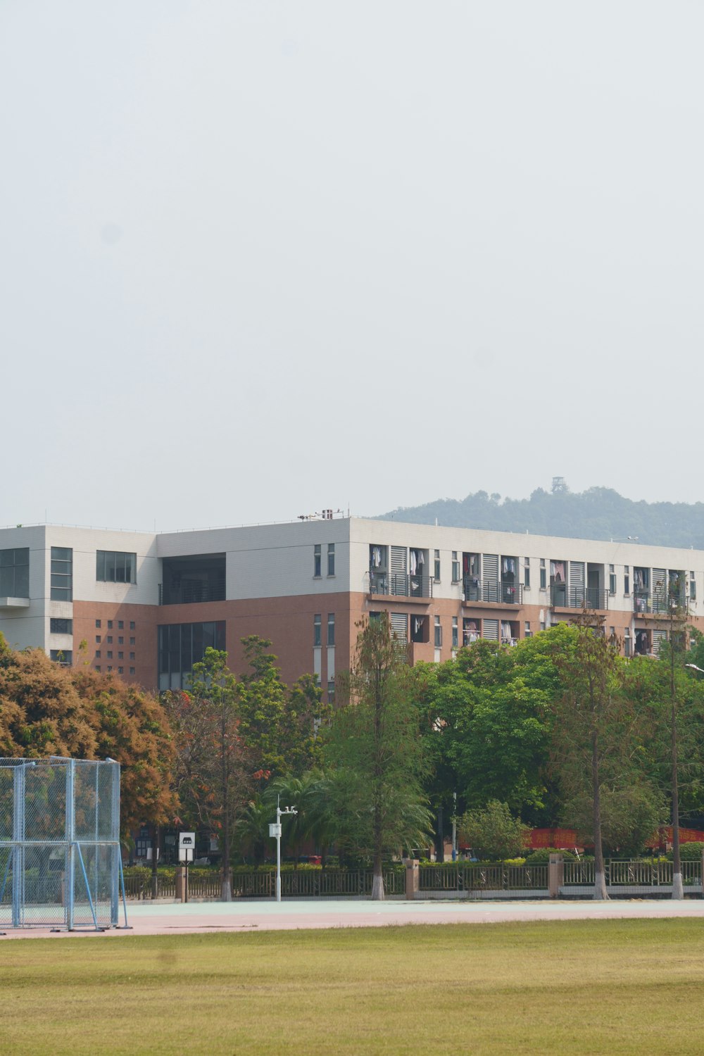 a field with a building in the background