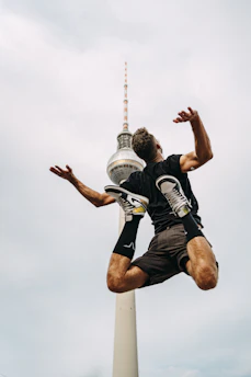 a man jumping in the air with a frisbee