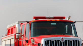 A bright red firetruck ready for action, gleaming under studio lights
