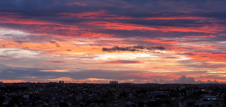 A vibrant digital artwork showcasing pixel art blending into a dynamic cityscape at sunset.