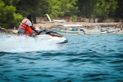a man riding a jet ski on top of a body of water