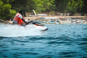 a man riding a jet ski on top of a body of water