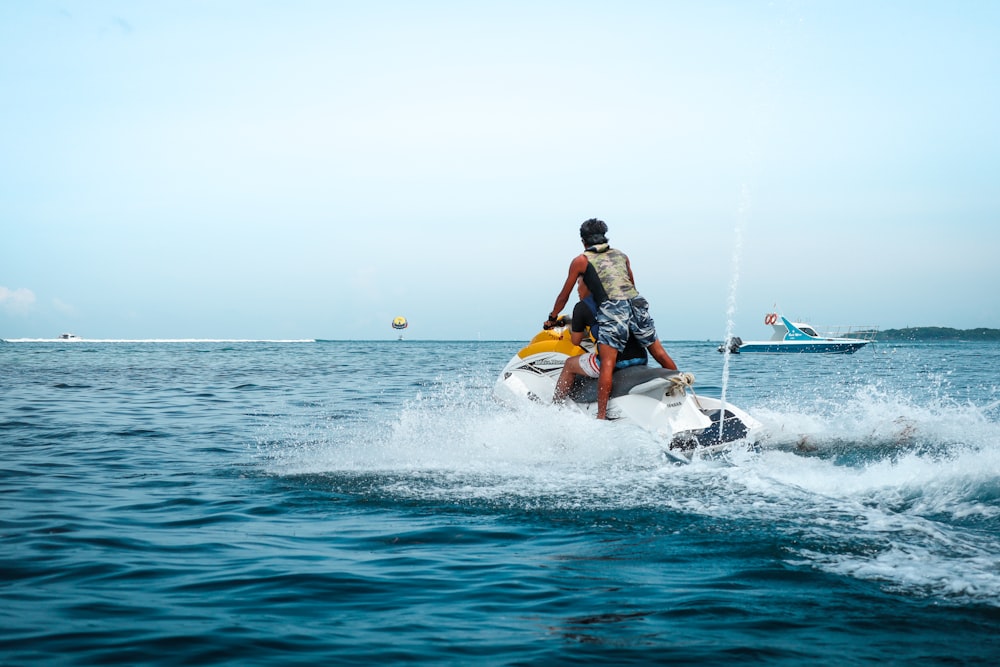 a man riding a jet ski on top of a body of water