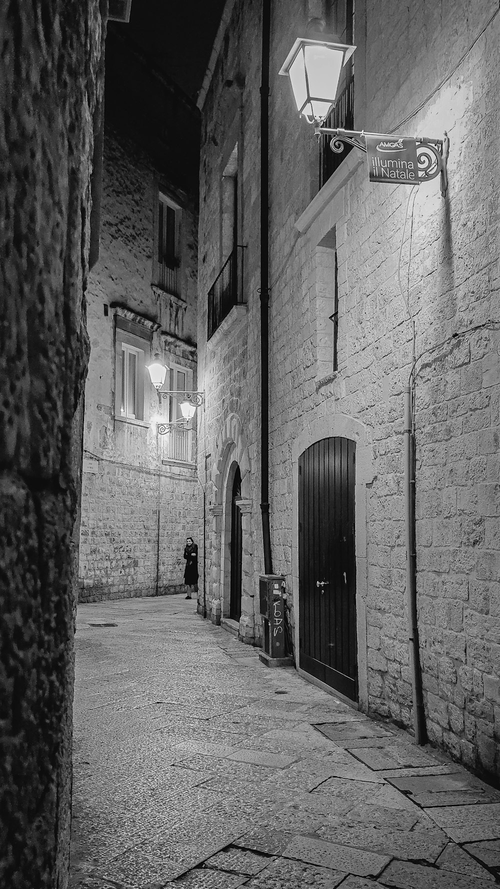 a black and white photo of a street at night
