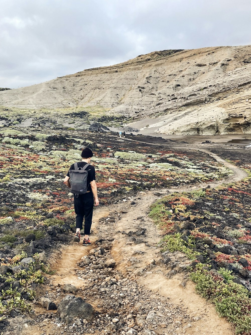 a person with a backpack walking on a trail