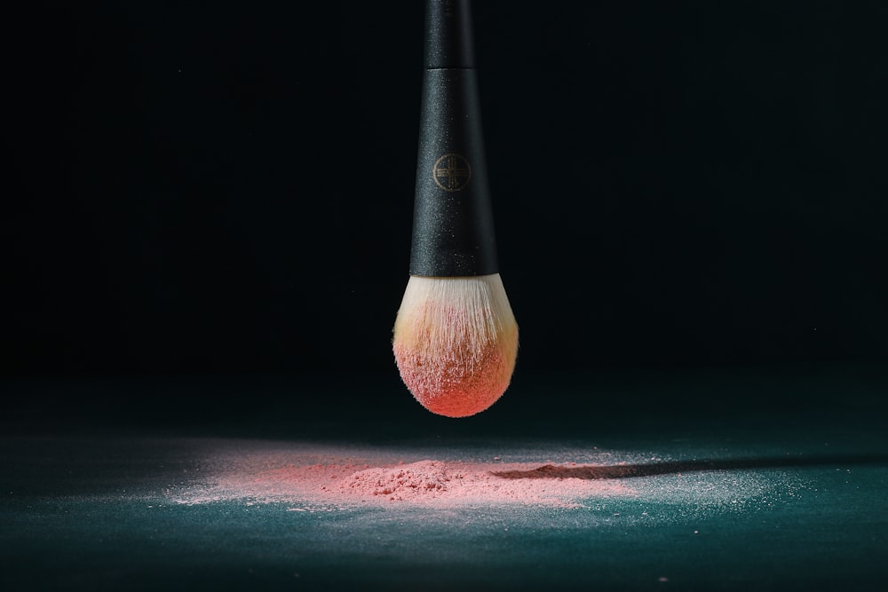 a close up of a makeup brush on a table
