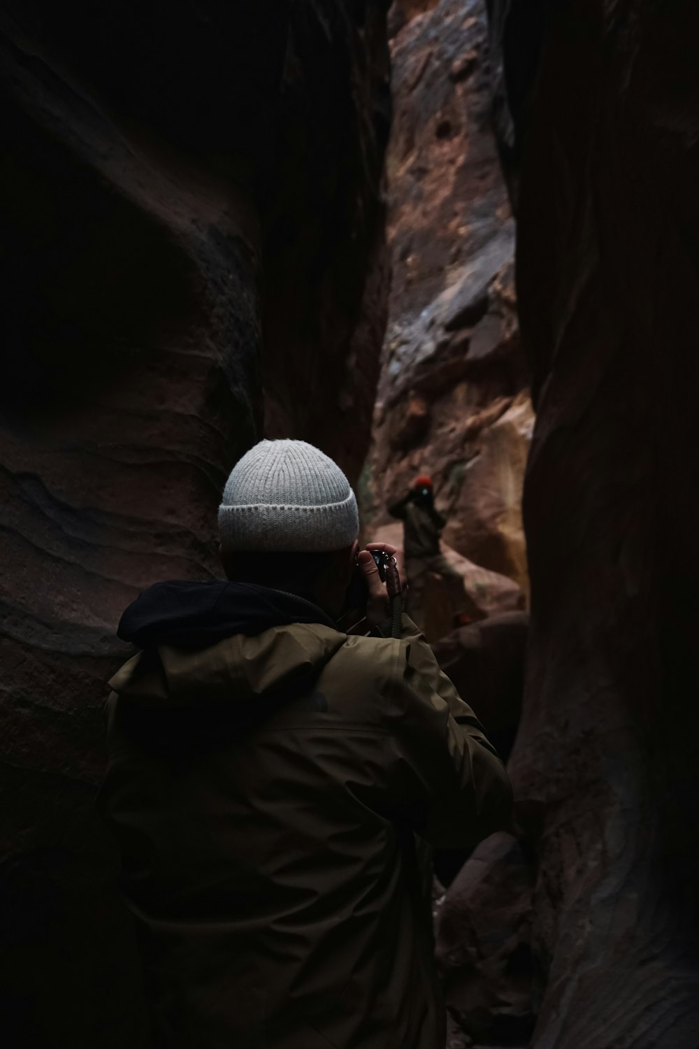 a man is taking a picture of himself in a narrow canyon