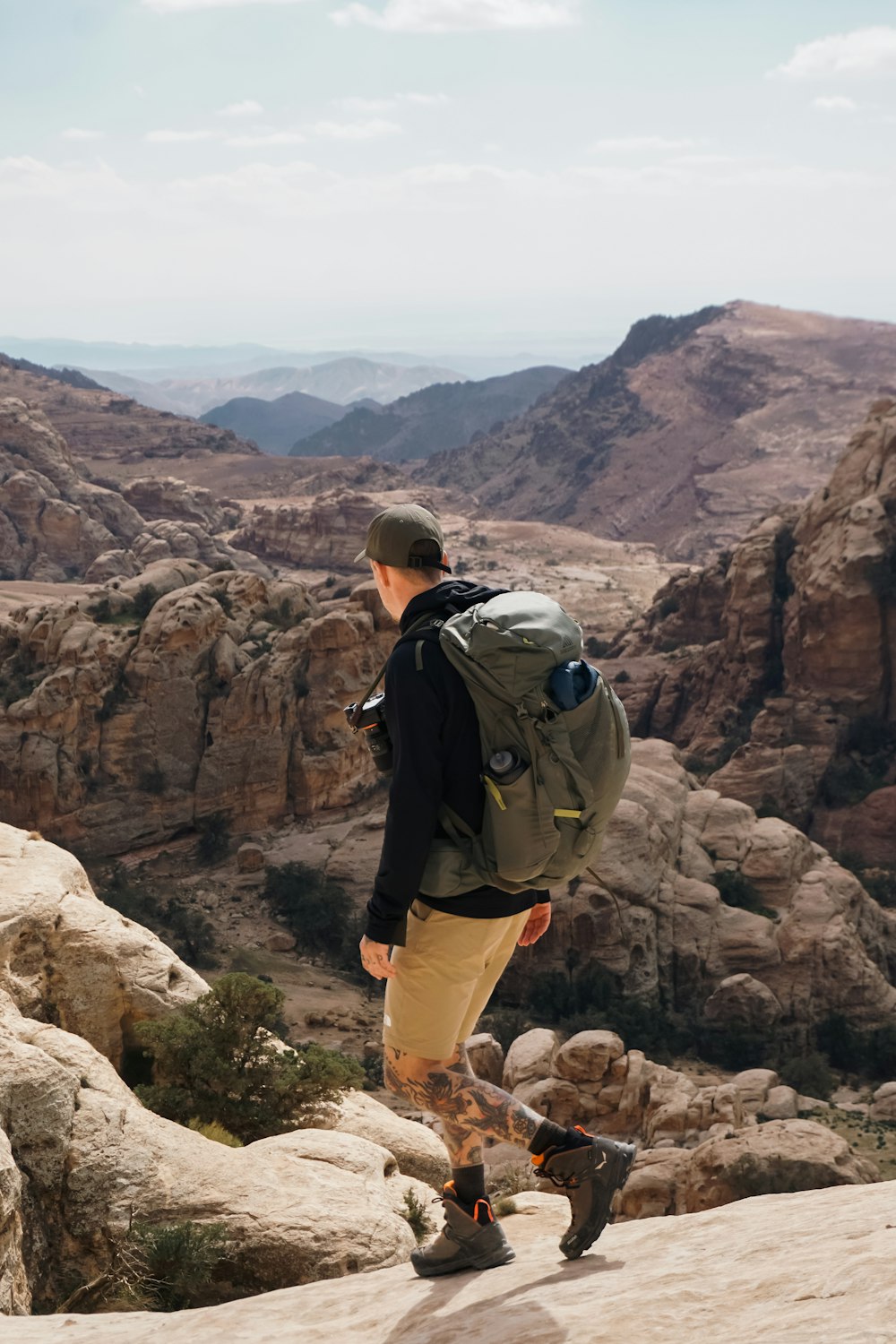 a man with a backpack walking up a mountain