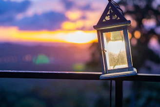 Elegant metal hanging garden lantern glowing softly at dusk