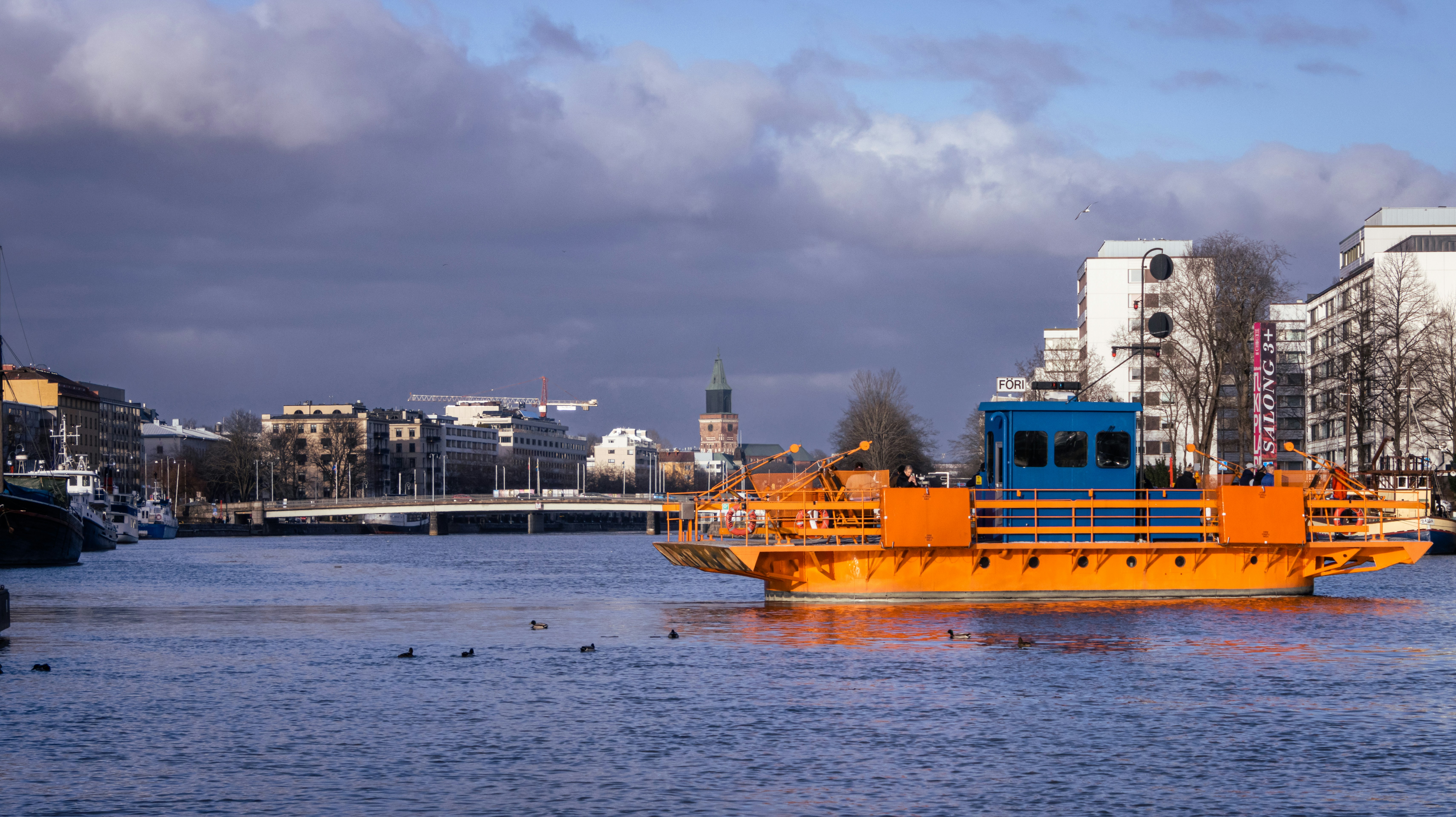 a large yellow boat floating on top of a body of water