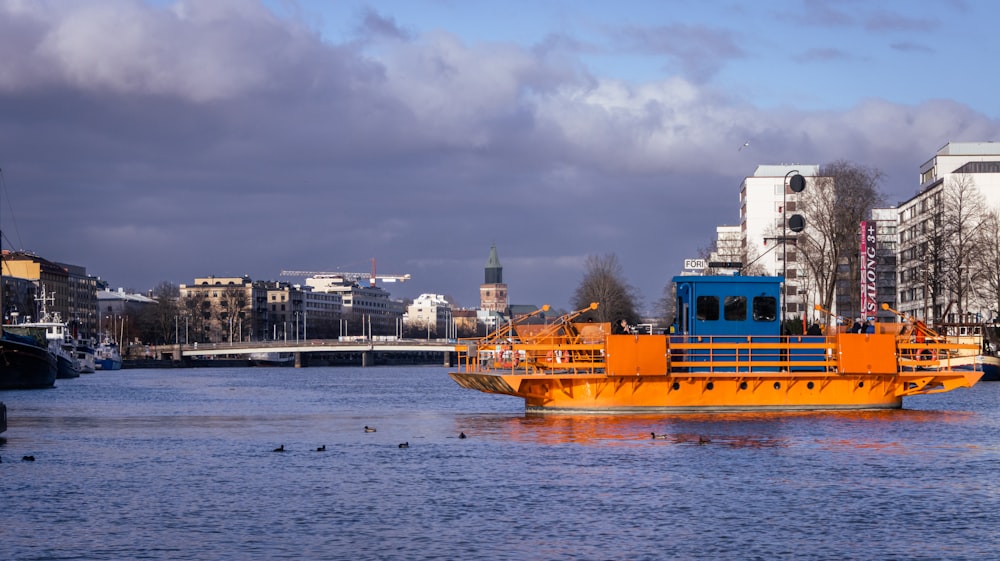 a large yellow boat floating on top of a body of water