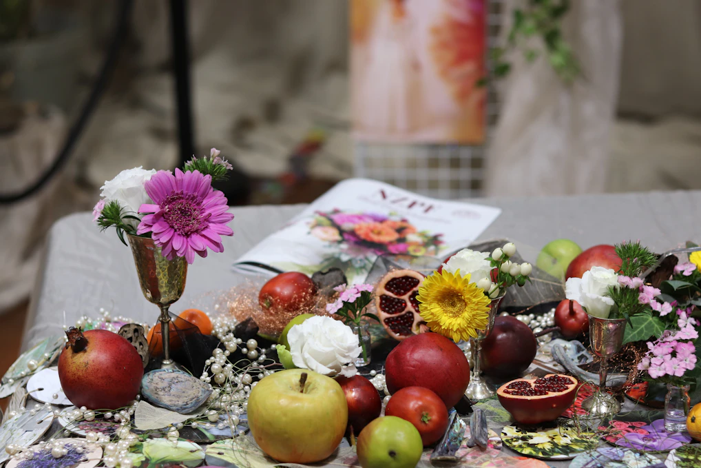 a table topped with lots of fruit and flowers