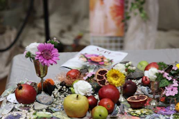 a table topped with lots of fruit and flowers