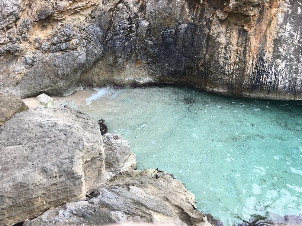 a body of water surrounded by large rocks