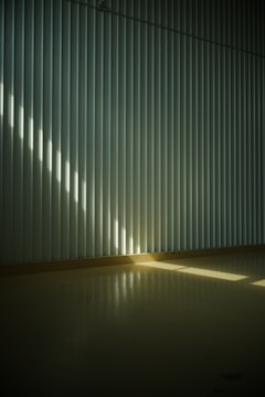 Detail of wall finishing showing crisp gypsum lines and textures in bright natural light.