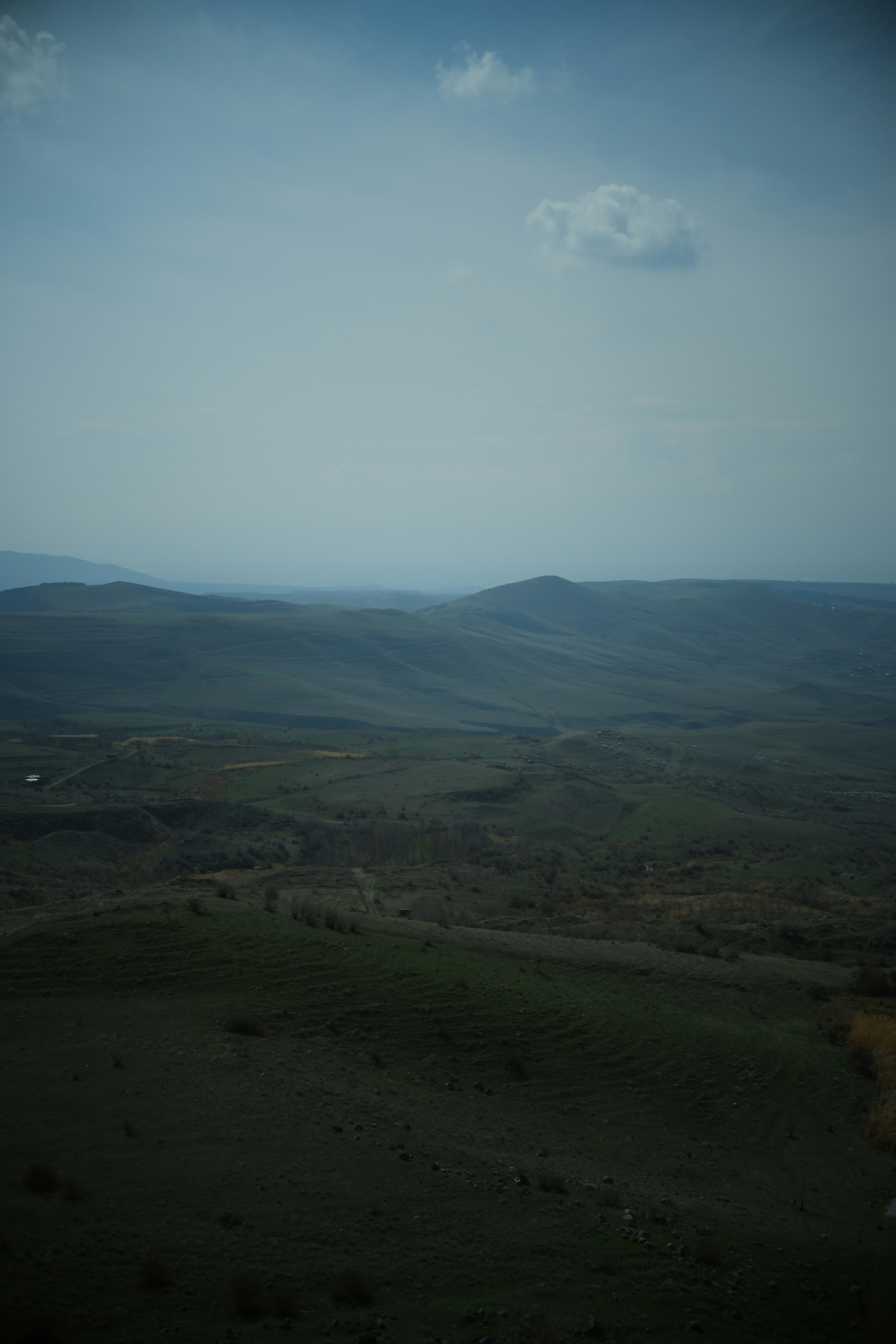 a view of a valley with hills in the distance