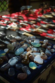 A collection of polished flint minerals displayed on a wooden surface with warm lighting.