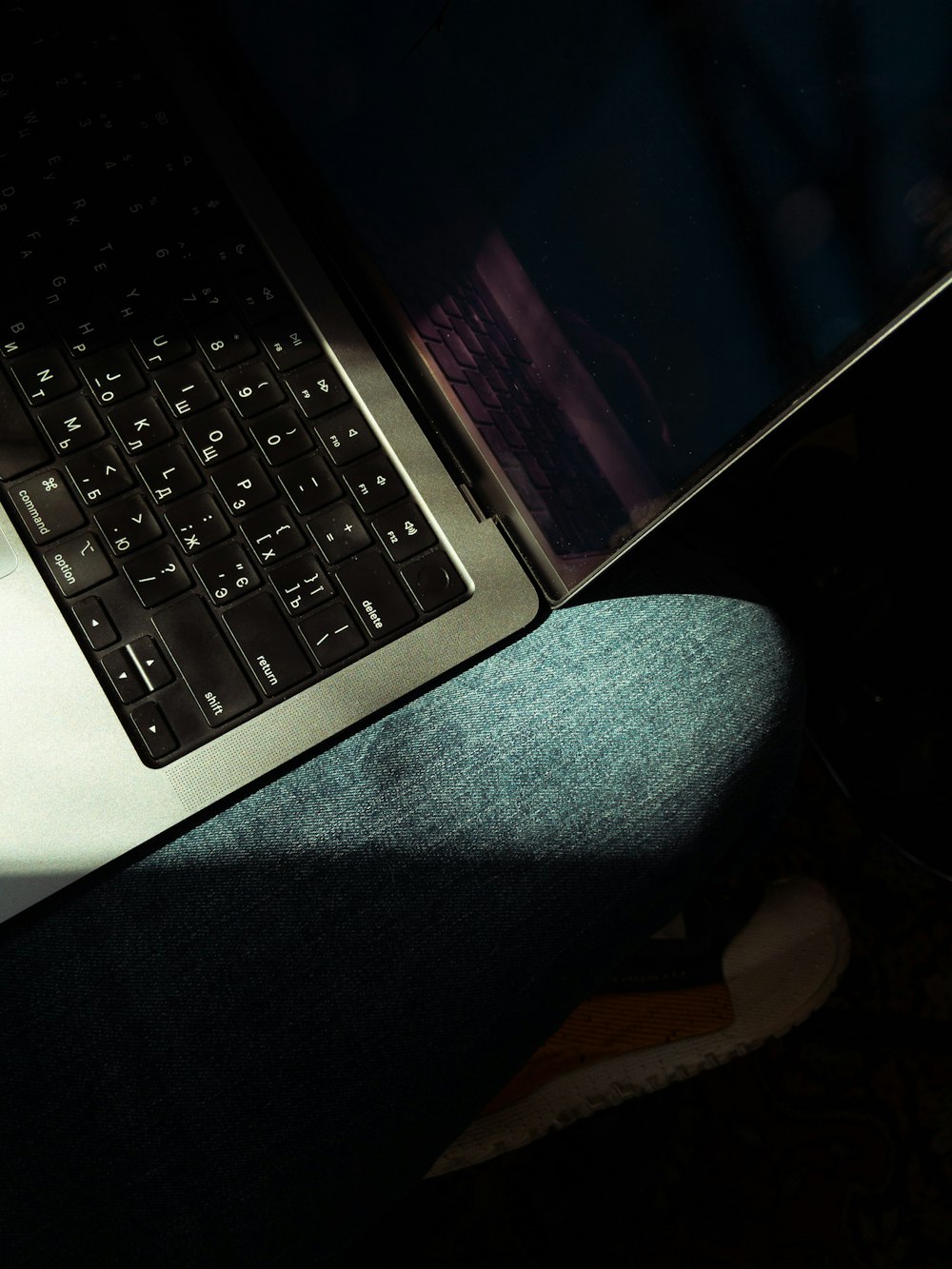 a laptop computer sitting on top of a persons lap