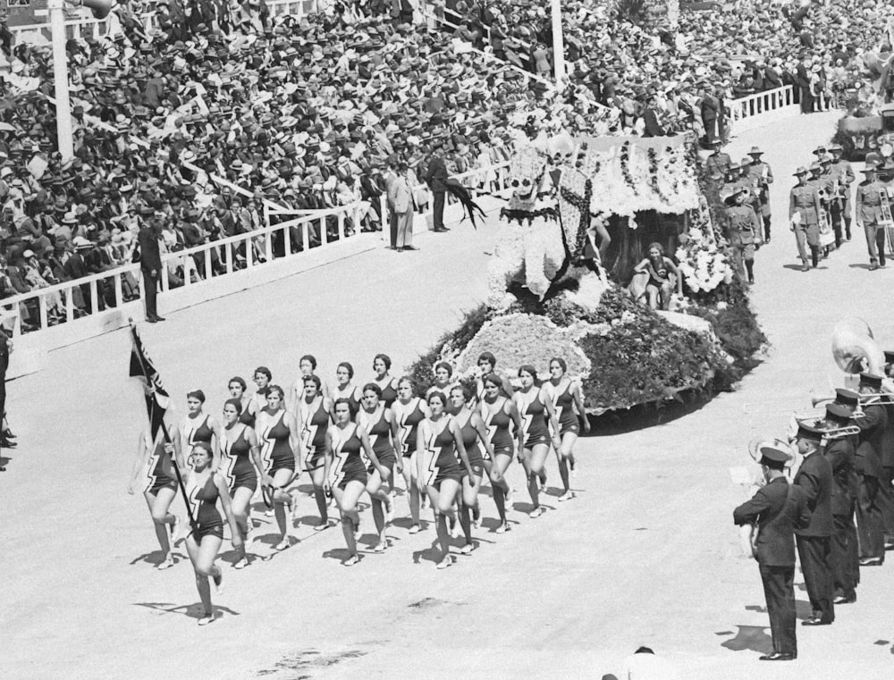 a parade of men and women marching down a street