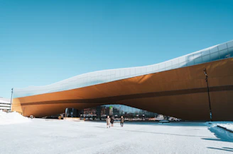 A warm, inviting photo of the Surrey Central Library entrance on a sunny Sunday morning.