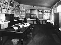 Editorial team members reviewing and correcting texts with focused expressions in a stylish, literary workspace.