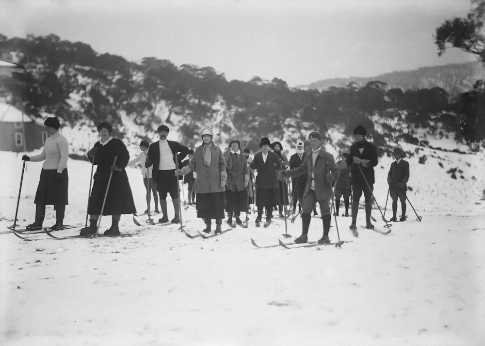 a group of people standing on top of a snow covered slope