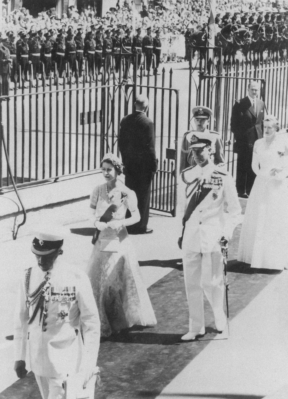 a group of people standing next to each other near a fence