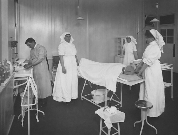a black and white photo of nurses in a hospital