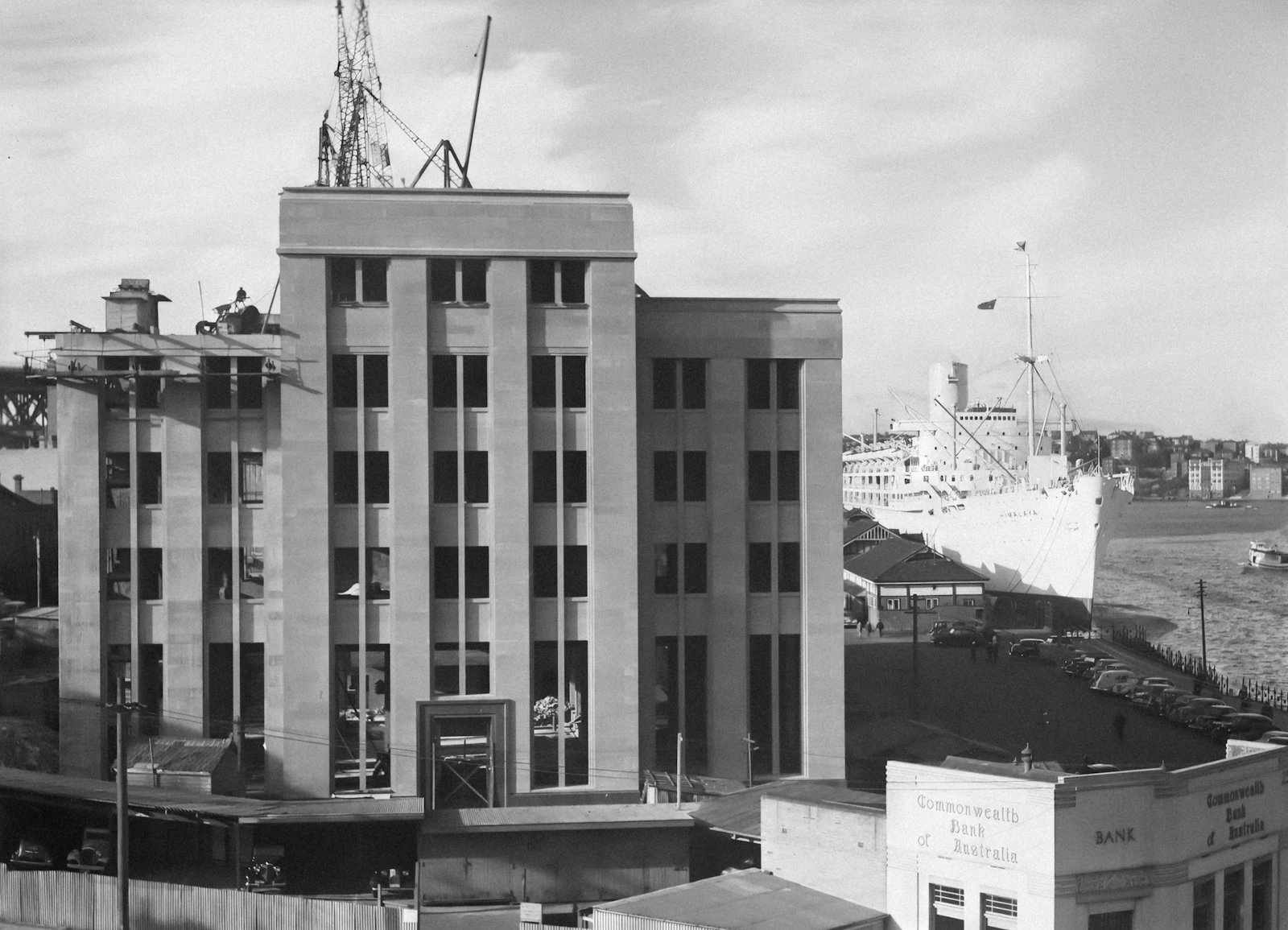 Black and white photo of a large office building representing corporate approval chains