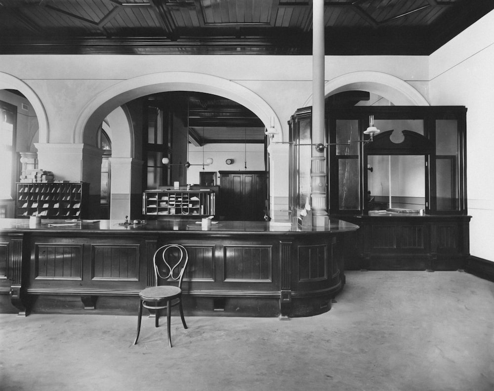 a black and white photo of a bar in a building