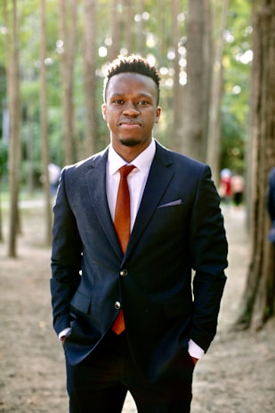 Garvan Olin standing confidently outdoors, the forest green accent subtly reflected in his jacket.