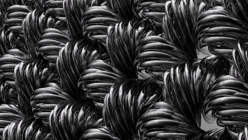 Abstract pattern of intertwined black and gray curves resembling twisted, shiny metallic or plastic material with a smooth, glossy texture.